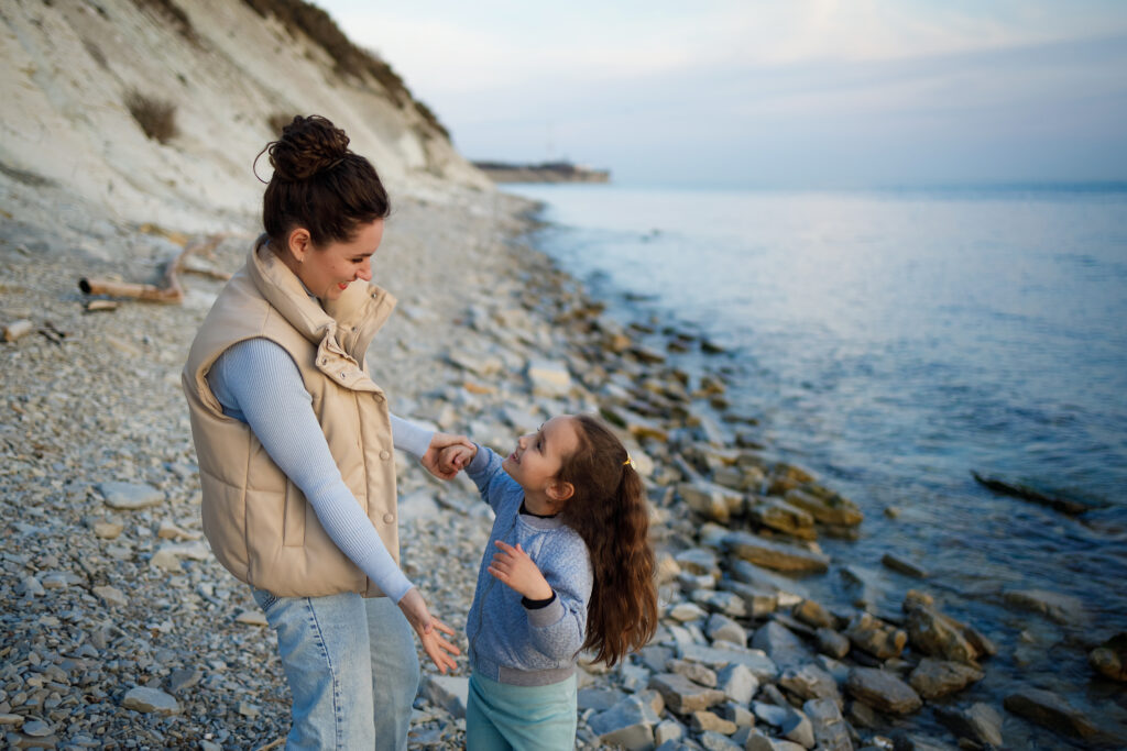 family-weekend-by-sea-happy-mother-daughter-have-fun-walk-sunset-sea (1)