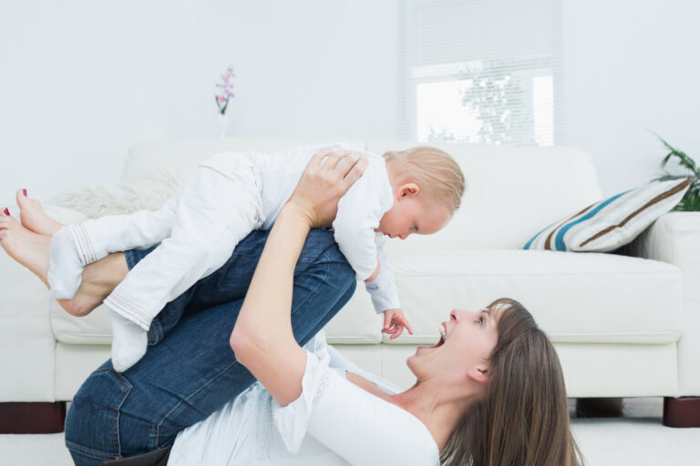 mother-lying-playing-with-baby