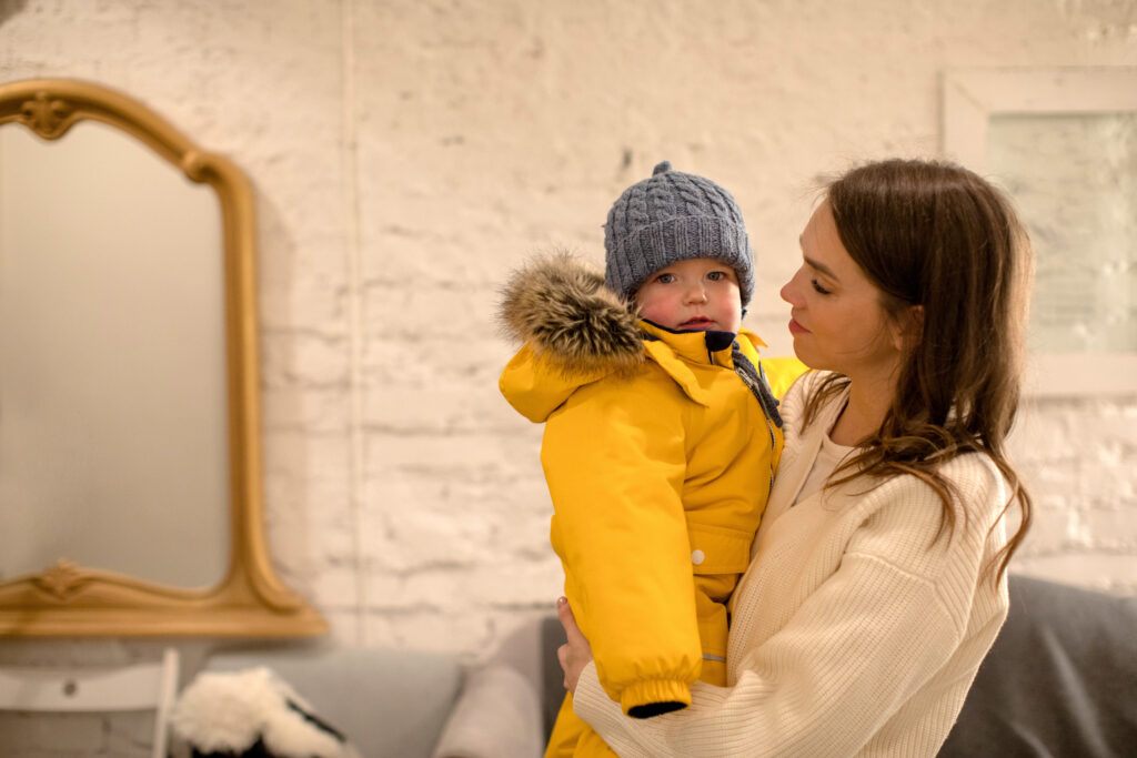 mother-with-little-child-warm-clothing-arms